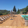 Swimming pool with loungers, umbrellas, and greenery at Camping d'Aix en Provence holiday park, France.