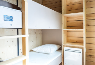 Bright, modern cabin room with bunk bed, shelving, and wood panel walls at Evasion Chalet, Aix en Provence.