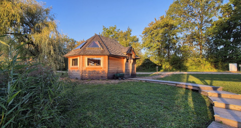 Wooden cabin at Domaine des Feuilles holiday park in Auvergne-Rhône-Alpes, France, surrounded by nature