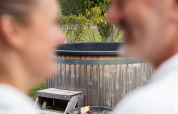 Blurred couple in white robes enjoying the private sauna and hot tub at ‘t Schuttenbelt in the Netherlands.