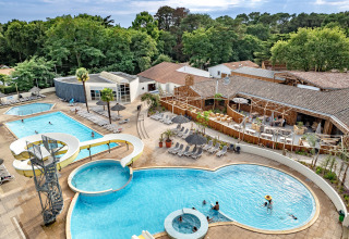Aerial view of the pool area and waterslide at Flower Camping Au Bois Des Biches, Pays de la Loire, France.