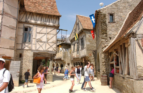 Mensen kuieren door een middeleeuws dorp met vakwerkhuizen bij Saint Hilaire de Riez, Pays de la Loire, Frankrijk.