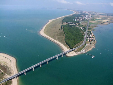 Aerial view of a bridge at Saint Hilaire de Riez, Pays de la Loire, France, linking the mainland to a narrow peninsula.