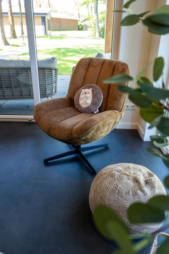 Cozy armchair and pouf in Wood Cottage + hot tub at Holiday park De Witte Berg in the Netherlands.