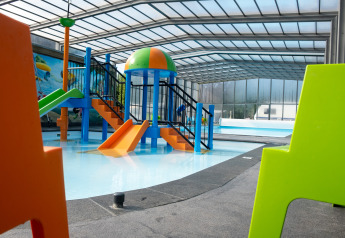 Indoor water playground with colorful slides and shallow pool at Holiday park De Witte Berg, Netherlands.