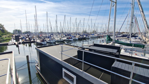 View from House boat 4-Almere at Marina Parcs Almere in the Netherlands, overlooking many sailboats.