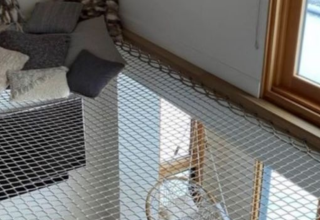 Cozy corner with pillows and netted floor inside a safari tent at Boerderij huisje, Beloofde Land, Netherlands.