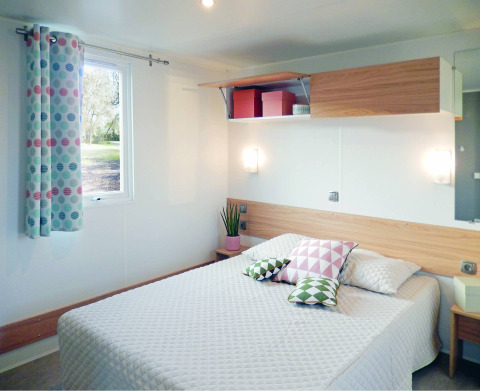 Modern chalet bedroom at Stacaravan Life, Flower Camping Au Bois Des Biches, France, with cozy decor.