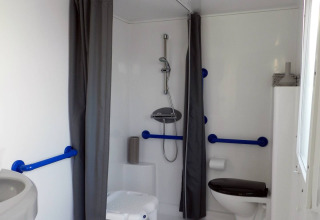 Accessible bathroom at Stacaravan Life, Flower Camping Au Bois Des Biches, with shower chair and grab bars.