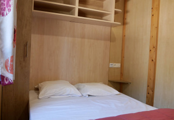 Soveværelse med dobbeltseng, hylder og trævæg på Cottage Family, Flower Camping Au Bois Des Biches, Frankrig