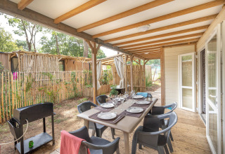 Comedor exterior cubierto en la cabaña Cottage Garden, Flower Camping Au Bois Des Biches, Francia, listo para comer.