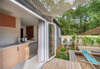 Modern Stacaravan Tribu chalet at Flower Camping Au Bois Des Biches in France, with deck and outdoor area.