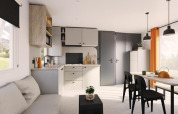 Modern living area and kitchen in Limburg Lodge at Campsite 't Geuldal, Netherlands, with bright decor.