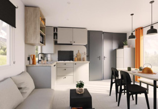 Moderne woonkamer en keuken in de Limburg Lodge op Camping 't Geuldal, Nederland, met lichte inrichting.