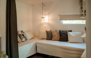 Cozy seating area with cushions in Coco Sweet safari tent at Campsite 't Geuldal in the Netherlands