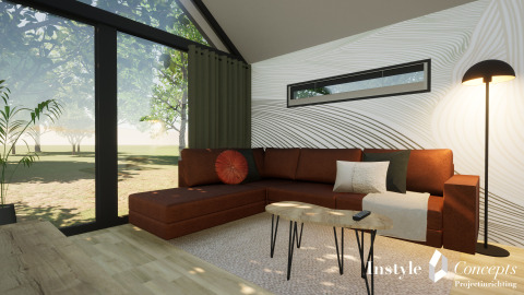 Moderne stue i Cosy Lodge ved Camping Si-Es-An med brun sofa, store vinduer og udsigt til naturen.