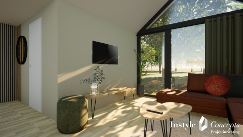 Lyst og moderne opholdsområde i Cosy Lodge på Camping Si-Es-An med store vinduer og naturudsigt.