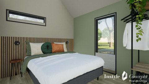 Moderne soveværelse med grøn væg, stor seng og minimalistisk indretning i Cosy Lodge på Camping Si-Es-An.