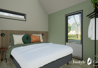 Chambre moderne avec mur vert, lit confortable et décoration élégante au Cosy Lodge du Camping Si-Es-An.