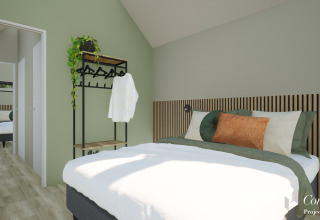 Soveværelse i Cosy Lodge på Camping Si-Es-An, Nederlandene, med grønne vægge og moderne indretning.