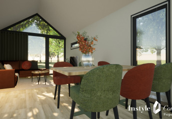 Intérieur de lodge cosy avec salle à manger moderne, chaises vertes et rouges, Camping Si-Es-An, Pays-Bas.