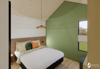 Moderne soveværelse i Reestdal lodge, Camping Si-Es-An, Holland med grønt accentvæg og hyggelig indretning.
