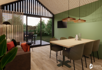 Modern living and dining area with green accent wall in Reestdal lodge at Camping Si-Es-An, Netherlands.