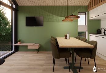 Salle à manger et cuisine modernes dans un lodge Reestdal au Camping Si-Es-An aux Pays-Bas, mur vert.