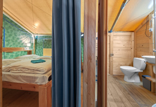 Interior of Safaritent Sunset with private bathroom and air conditioning at Camping Polari in Croatia.