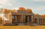 Moderne lodge Villa Hottub bij Resort de Parel in Nederland, met terras, herfstbomen en een buiten-hottub.