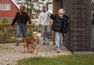 Famiglia con cane arriva a Vakantievilla Amalia 4 con sauna e vasca idromassaggio a Hofparken De Bergvennen.