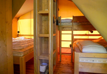 Indvendig udsigt af safaritelt til 5 personer med køjeseng og dobbeltseng ved Camping De Rammelbeek.
