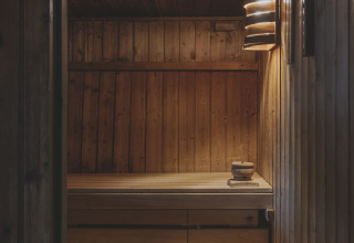 Houten sauna met banken en sfeervolle verlichting bij Wecamp Pedraforca vakantiepark in Catalonië, Spanje.