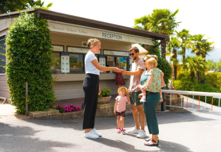 Familie checkt an der Rezeption des Weekend Glamping Resort, einem Ferienpark in der Lombardei, Italien, ein.