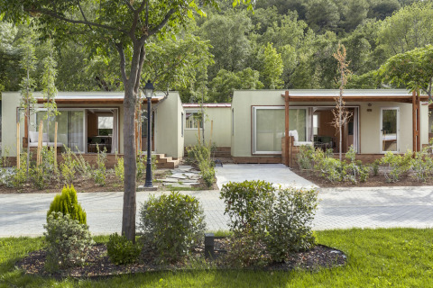 Bungalows modernes au parc de vacances Wecamp Pirineos en Aragón, Espagne, entourés de verdure.