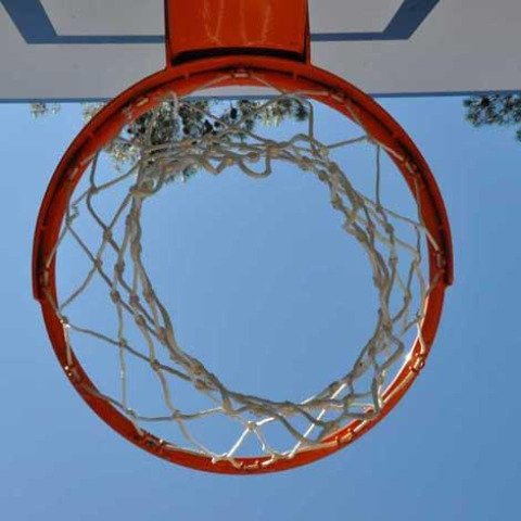 Aro de baloncesto y red vistos desde abajo en Wecamp L'Escala Punta Mila, un parque de vacaciones en Cataluña, España.