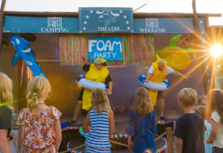 Children watch a fun stage show at Weekend Glamping Resort in Lombardy, Italy, with costumes and props.