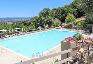 Piscine extérieure au Vallicella Glamping Resort en Toscane, Italie, entourée de collines verdoyantes.