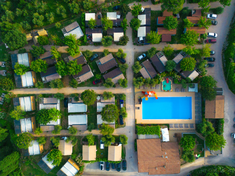 Aerial view of Vacanze Glamping Boutique holiday park in Lombardy, Italy, with pool and cabins.