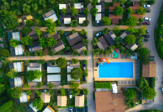 Aerial view of Vacanze Glamping Boutique holiday park in Lombardy, Italy, with pool and cabins.