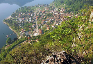 View of Lago Idro Glamping Boutique holiday park in Lombardy, Italy, showing the lake and greenery.