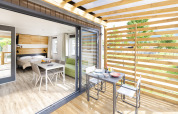 Licht interieur en terras van Cube Suite XL in Lago Idro Glamping Boutique, Italië, met eettafel en stoelen.