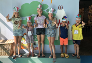 Kids wearing chef hats smile and give thumbs up at Lago Idro Glamping Boutique in Lombardy, Italy.