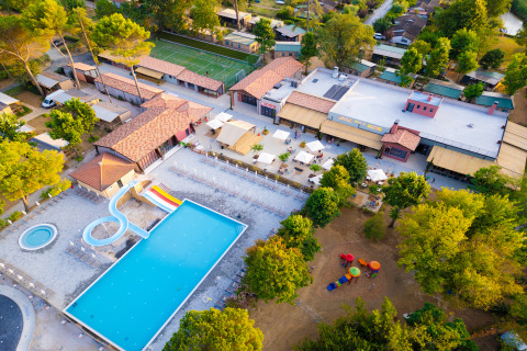 Aerial view of Trasimeno Glamping Resort in Umbria, Italy, showing swimming pool, slides and facilities.