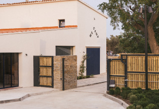 Entrance to Wecamp Cadaqués holiday park in Catalonia, Spain, featuring modern building and landscaping.