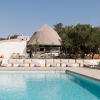 Outdoor pool area at Wecamp Cadaqués holiday park in Catalonia, Spain, featuring modern lounge seating.