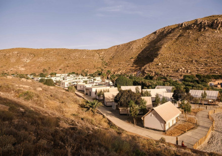 Vakantiepark met tenthuisjes in een droog, heuvelachtig landschap bij Wecamp Cabo de Gata, Andalusië, Spanje.