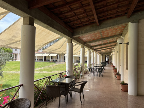 Terrasse couverte avec tables et chaises au parc de vacances Wecamp Sao Miguel en Alentejo, Portugal.