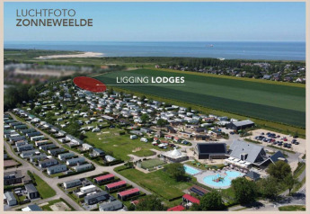 Foto aerea del Camping Zonneweelde nei Paesi Bassi con lodge, piscina e vicinanza alla spiaggia.