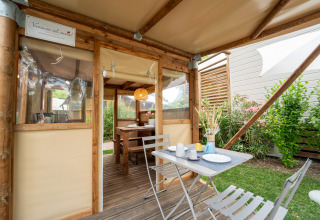 Tente safari « Air Stay XL » au Vallicella Glamping Resort en Italie, coin repas extérieur et ambiance chaleureuse.